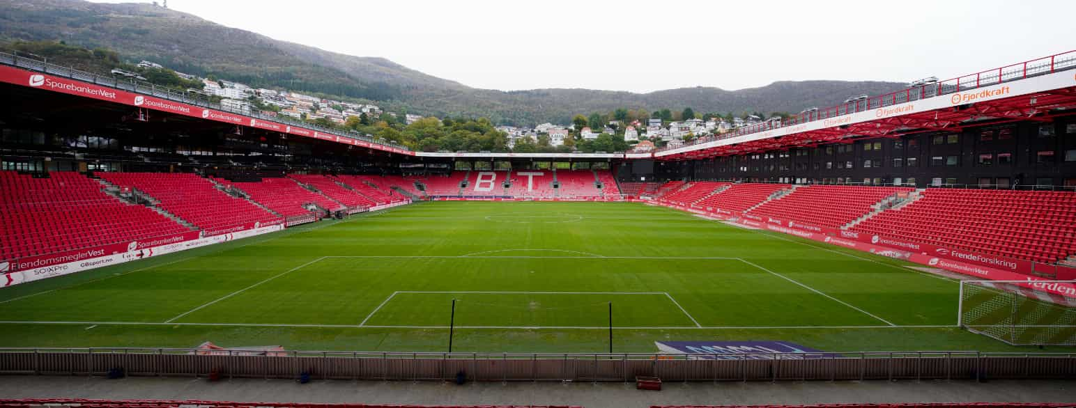 Foto av fotballstadion, to langsider på hver side og den ene kortsiden lengst bort med fjell i bakgrunnen.