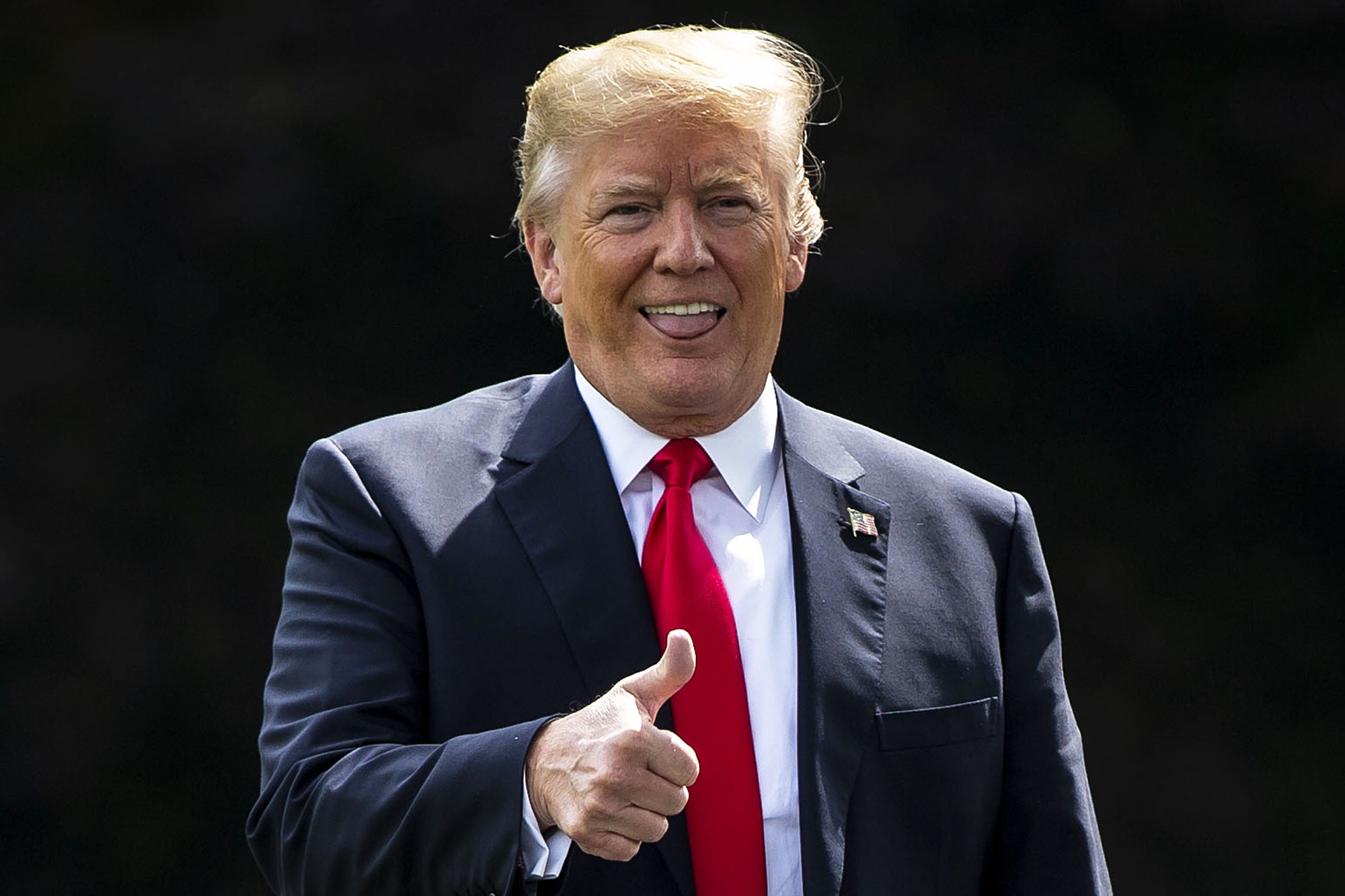 Donald Trump giving a thumbs up while walking to Marine One on the South Lawn of the White House in 2018.