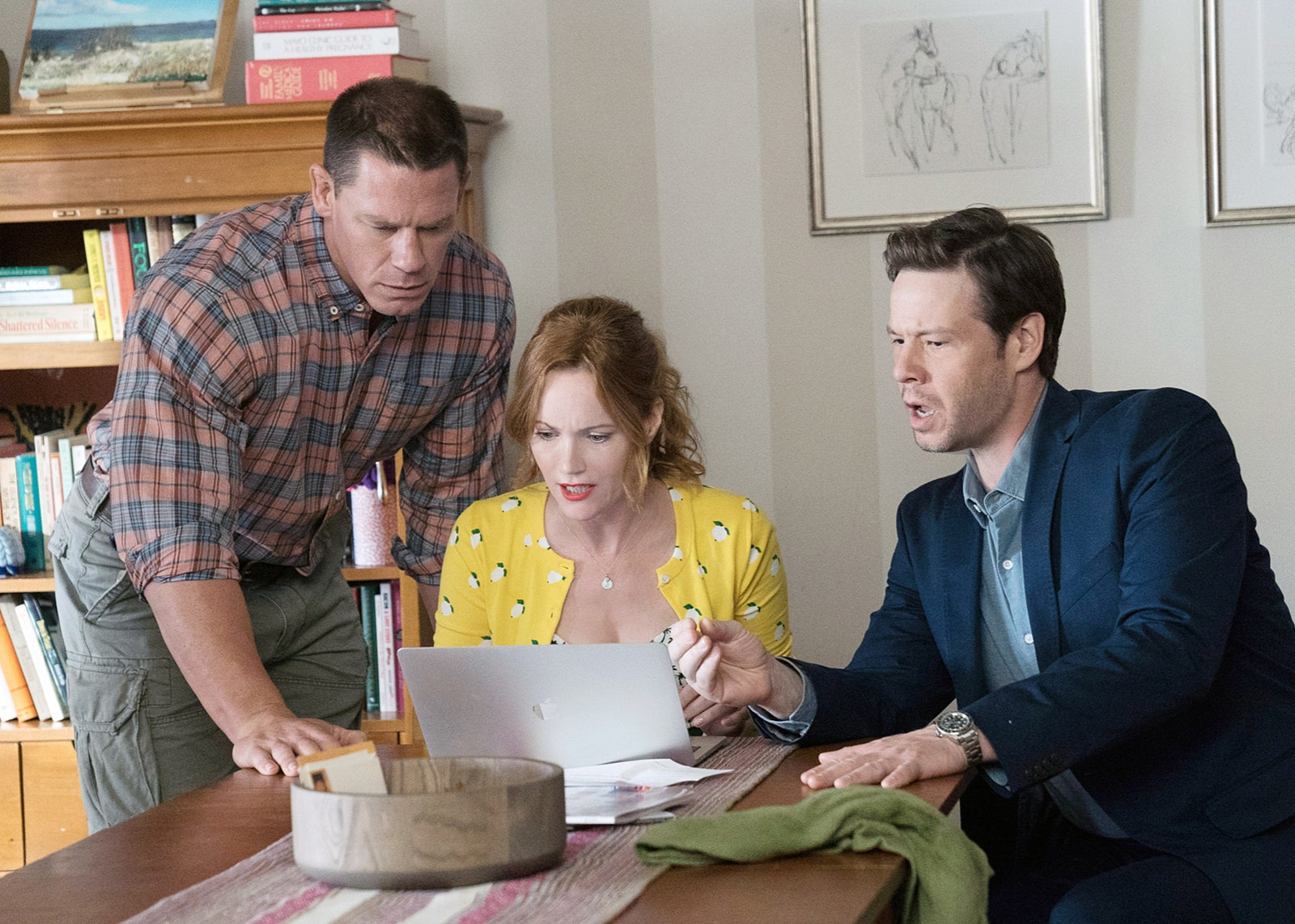 Image may contain Ike Barinholtz John Cena Leslie Mann People Person Wristwatch Adult Desk Furniture Table and Art