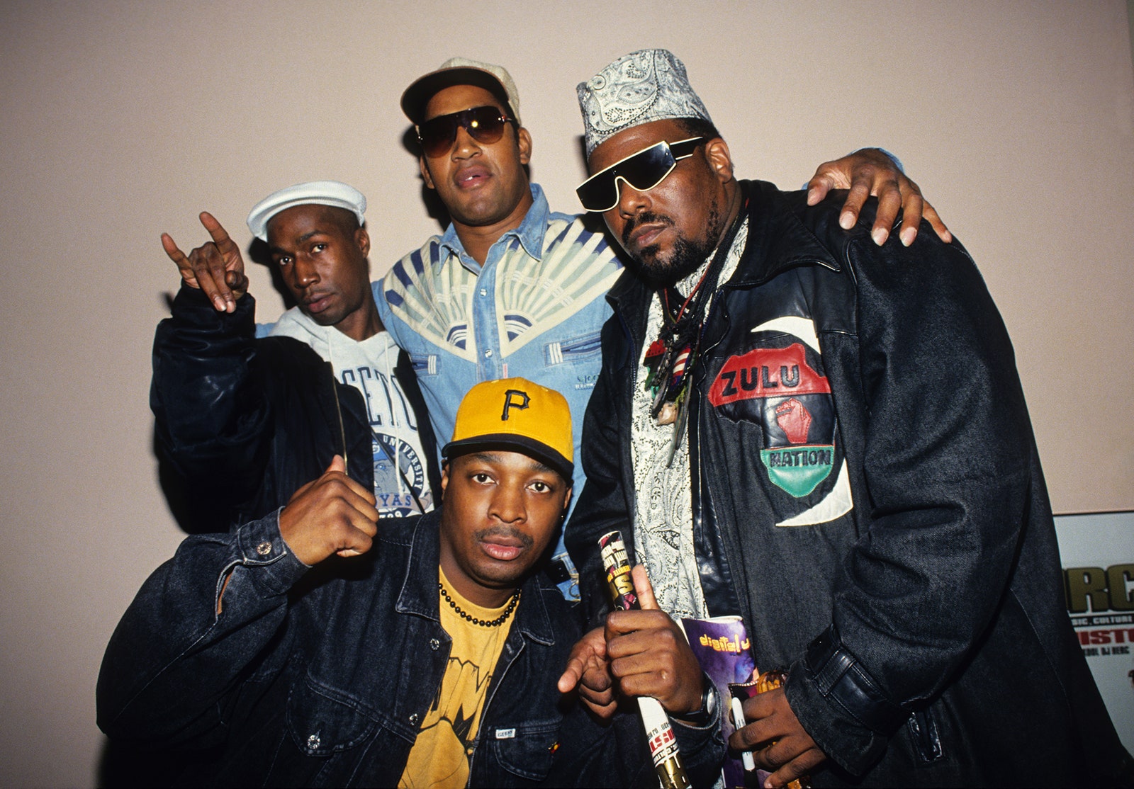 Image may contain Afrika Bambaataa Chuck D DJ Kool Herc Grandmaster Flash Clothing Coat Jacket Baseball Cap and Cap