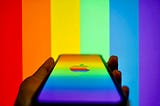 An iPhone illuminated in futuristic rainbow colors | Photo by surasak_ch on Unsplash