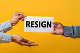 Close up photo of a man’s two arms with grey shirt handing over a white envelope “RESIGN” to his boss’s hands, yellow background. AI image created on Midjourney v6 by Henrique Centieiro and Bee Lee.