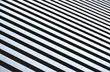 A diagonal photo of tiling in the pattern of black and white zebra stripes.