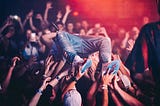 Singer crowd surfing in the audience.