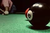 The 8-ball in close-up on a pool table
