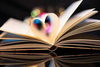 A book with its pages open in the shape of a heart