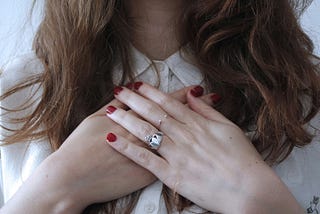 woman with hands over heart