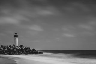 lighthouse overlooking rocks and the beach