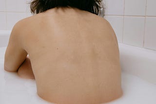 A woman sitting in a bathtub