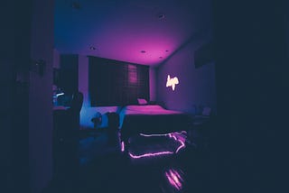 A neon lit bedroom