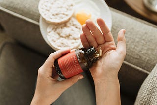 A person with a supplement bottle in their hand