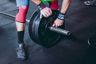 athlete fixing weights in the gym