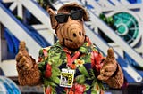 ALF, a puppet from the 80s, wearing sunglasses and a Hawaiian shirt