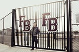 A photo of my son standing in front of a gate leading into the football stadium hours before his final high school football game during his senior year.