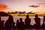 A group of friends watching the sunset.