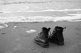 Dr Martens shoes by on the shoreline in IJmuiden, the Netherlands.