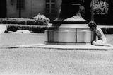 A terrified student hides behind the concrete base of a flagpole during the Aug. 1, 1966 University of Texas mass shooting.