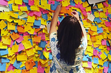 Woman infront of lots of sticky notes