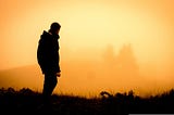 A man looking at the sunset.