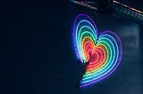 A rainbow heart on a black background