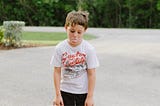 An image of a young boy sticking out his tongue