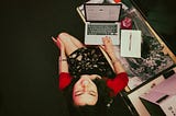 a young woman, the author, sits at a desk smiling