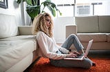 Woman working on a laptop.