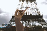 Woman leaning near Eiffel Tower