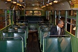 President Barack Obama sits on the bus where Rosa Parks changed history, sparking the civil rights movement. She was told to move to the back of the bus to make room for a white passenger, and she refused to move. Obama has also refused to move, remaining the most important Democratic leader 20 years after he burst onto the national stage and more than seven years since leaving the White House. The bus is displayed at the Henry Ford Museum in Dearborn, Michigan. White House photo.