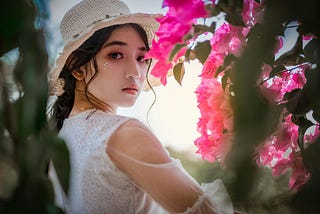 Beautiful woman in garden looking back at the camera.