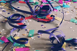 Colorful ribbon and confetti on sidewalk