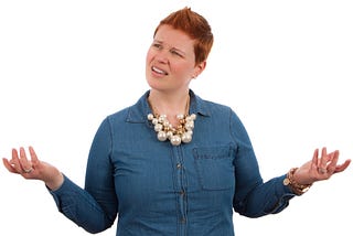 Caucasian woman with short red hair looking confused