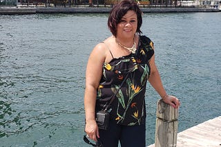 Picture of the author standing on a pier at the lake.