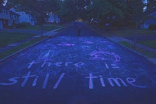 A screenshot from the movie “I Saw the TV Glow” showing a chalk drawing on the street.