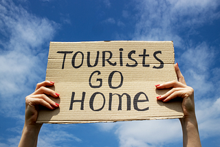 Tourists go home placard