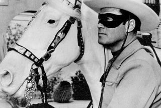 B&W Photo of Clayton Moore as the Lone Ranger next to his horse Silver