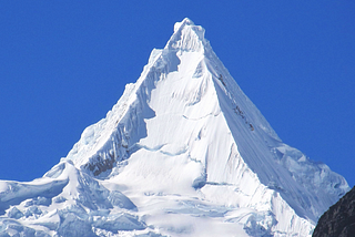 Mt. Alpamayo, Peru (19,511 ft, 5,947 m). Photo by Frank R 1981, on Wikipedia.