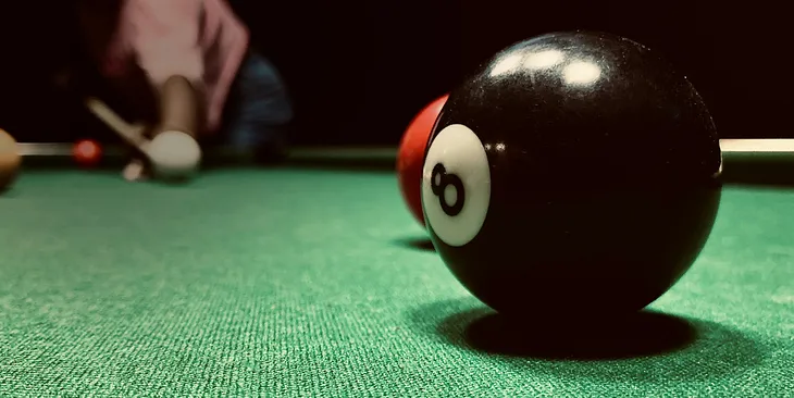 The 8-ball in close-up on a pool table