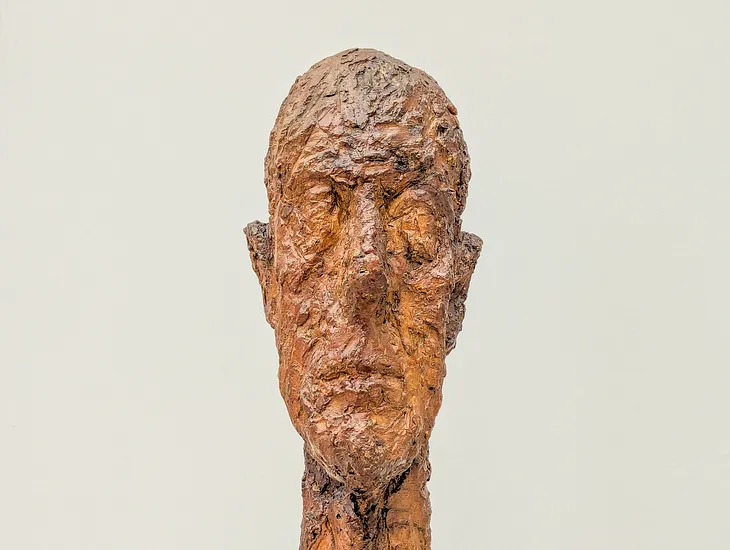 Sculpture of a narrow head, roughly hewn