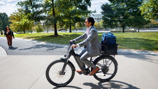 A student bikes to class near Rockefeller Hall.