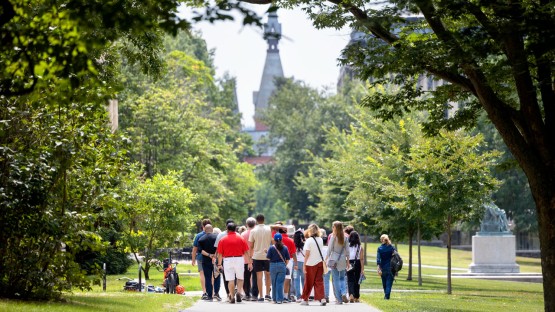 A summer tour group makes its way through the Arts Quad.