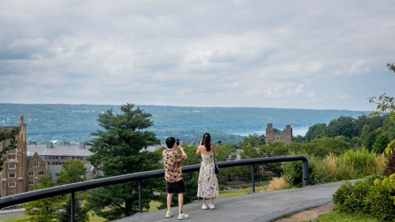 Students take a photo of west campus and Cayuga Lake near Olin Library.