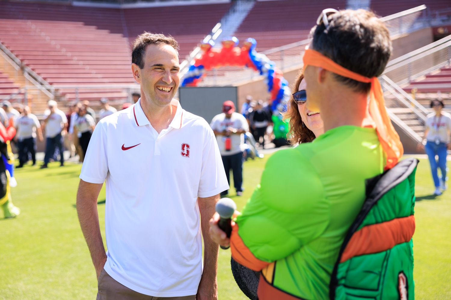 President Jonathan Levin talks to a participant in a Ninja Turtle costume before the Cardinal Walk begins.