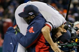 Red Sox slugger David Ortiz picks up Koji Uehara after the Red Sox beat the Tigers in Game 5.