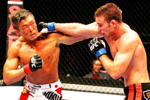 Jake Shields (right) and Yoshihiro Akiyama exchange blows in a February 2012 fight