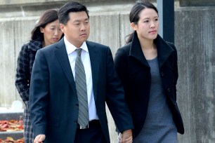 Accused Goldman Sachs rapist Jason Lee, arrives at Suffolk County Criminal Court alongside his wife in October, 2013.