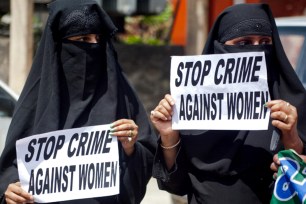 Female workers in India hold up signs during a protest over the alleged rise in rape cases June 9th in Srinagar, India.