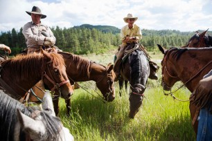 Rancher Steve Pargin and cowboy David Thompson (R) talk with the rest of the crew during a cattle drive near Ignacio, Colorado June 12, 2014. The land where the cattle graze is leased from the Forest Service by third-generation rancher Steve Pargin. Several times a year, he and a crew led by his head cowboy, David Thompson, spend a week or more herding cattle from mountain range to mountain range to prevent them from causing damage to fragile ecosystems by staying in a single area too long. Picture taken June 12, 2014. REUTERS/Lucas Jackson (UNITED STATES - Tags: ANIMALS AGRICULTURE ENVIRONMENT BUSINESS TPX IMAGES OF THE DAY) ATTENTION EDITORS PICTURE 13 OF 36 FOR PACKAGE 'COLORADO CATTLE DRIVE' SEARCH 'LUCAS CATTLE' FOR ALL IMAGES