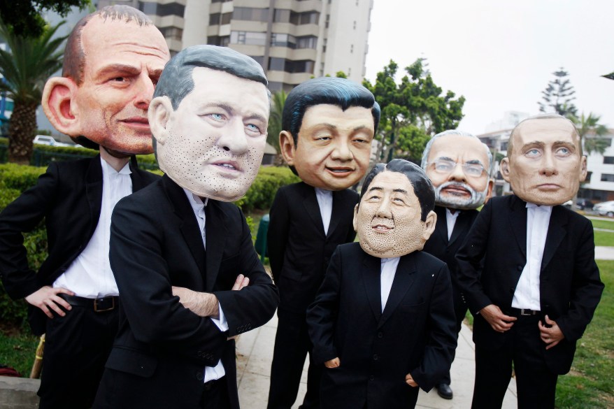 Activists wearing masks depicting (L to R) Australia's Prime Minister Tony Abbott, Canada's Prime Minister Stephen Harper, China's President Xi Jinping, Japan's Prime Minister Shinzo Abe, India's Prime Minister Narendra Modi and Russia's President Vladimir Putin are seen before they demonstrate to demand cuts in global emissions during the U.N. Climate Change Conference COP 20 in Lima December 12, 2014. The two-week long United Nations climate summit opened on December 1 in Lima, with experts and analysts from around the world gathering to discuss melting glaciers and extreme weather patterns. Protesters also urged international leaders to reach an agreement at the Paris Conference 2015, a deal to drive climate action beyond 2020. REUTERS/Enrique Castro-Mendivil (PERU - Tags: ENVIRONMENT CIVIL UNREST POLITICS TPX IMAGES OF THE DAY)