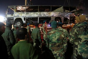 Afghan security forces inspect at the site of a suicide attack in Kabul.